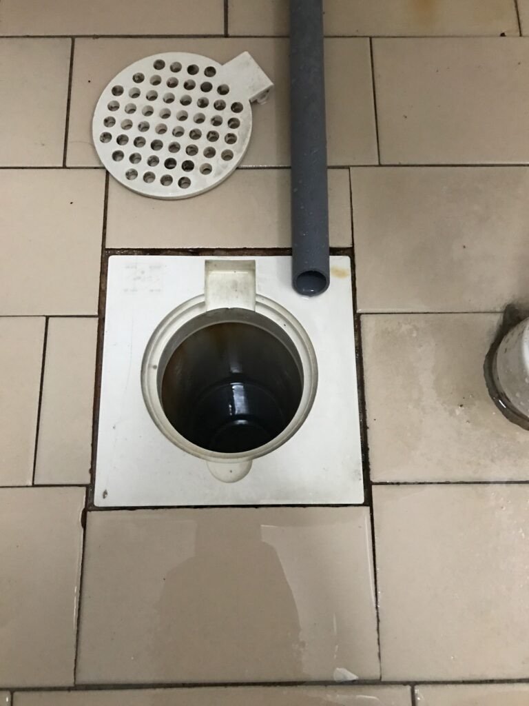 Floor trap with the cover removed, showing the drain below